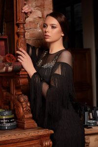 Short dress made of tulle featuring lots fringes and adorned with Chantilly lace onto shoulders