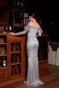 Mermaid dress made of solsstiss lace featuring tulle sleeves and silver embellished fringe trim