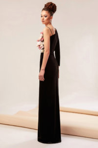 Velvet gown featuring a front split and asymmetrical neckline adorned with handmade flowers