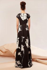 “A” shaped dress made of triple veil featuring a cut out at the waist and a front split