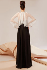 Gown made of natural silk veil featuring a mantle presenting handmade flowers appliques